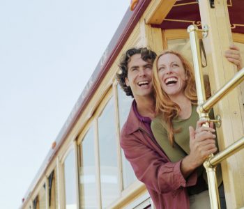 Smiling Couple Riding Cable Car